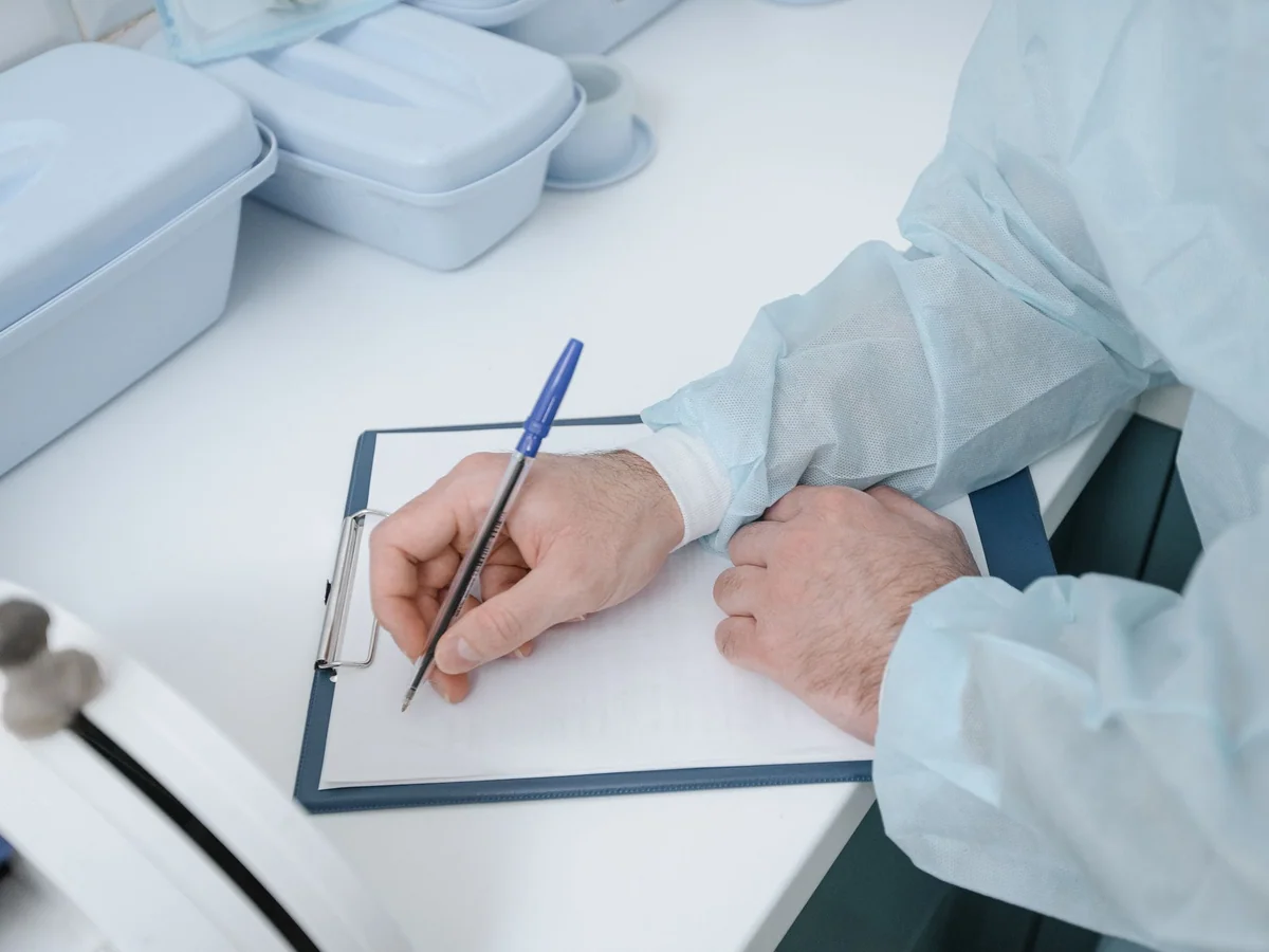 Woman speaking with a relative while taking careful health history notes