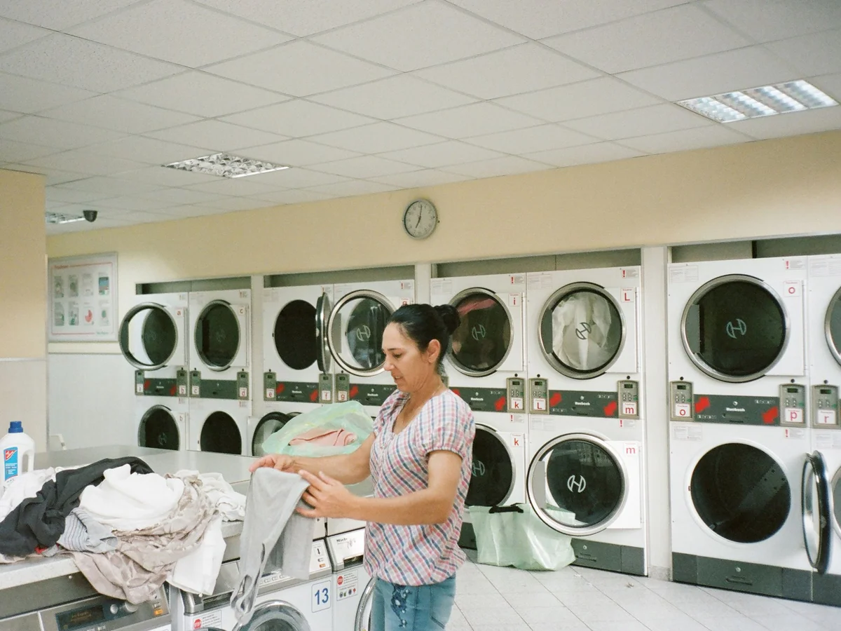 Woman sorting household laundry using a simple labeled system