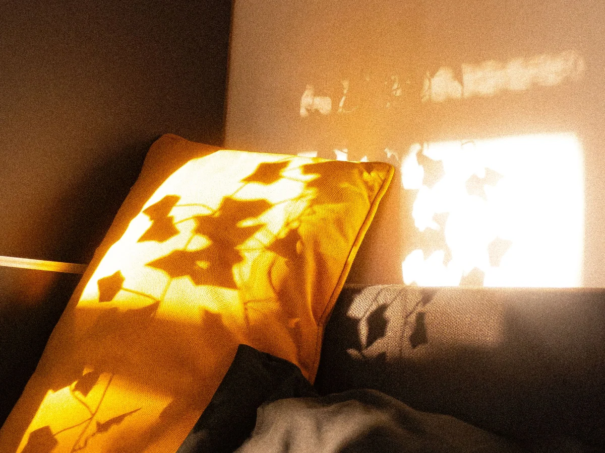 Woman settling into a calm sleep-friendly bedroom