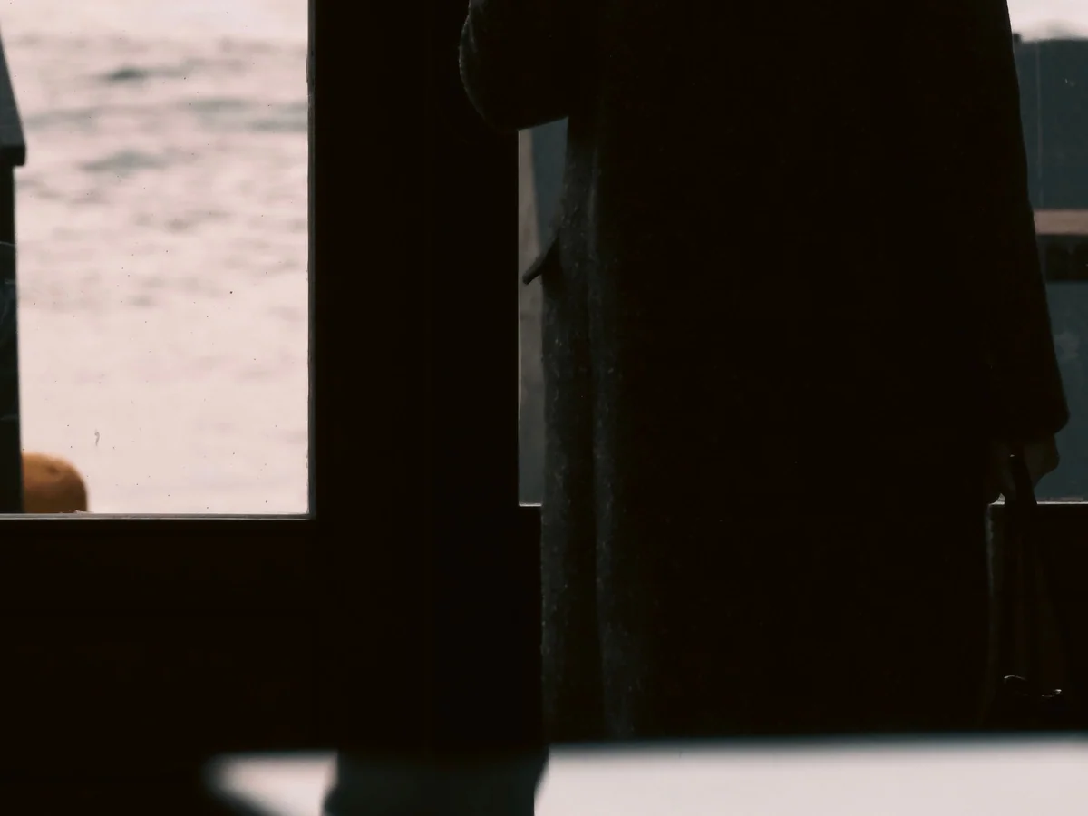 Woman pausing for a mindful breathing exercise by a window