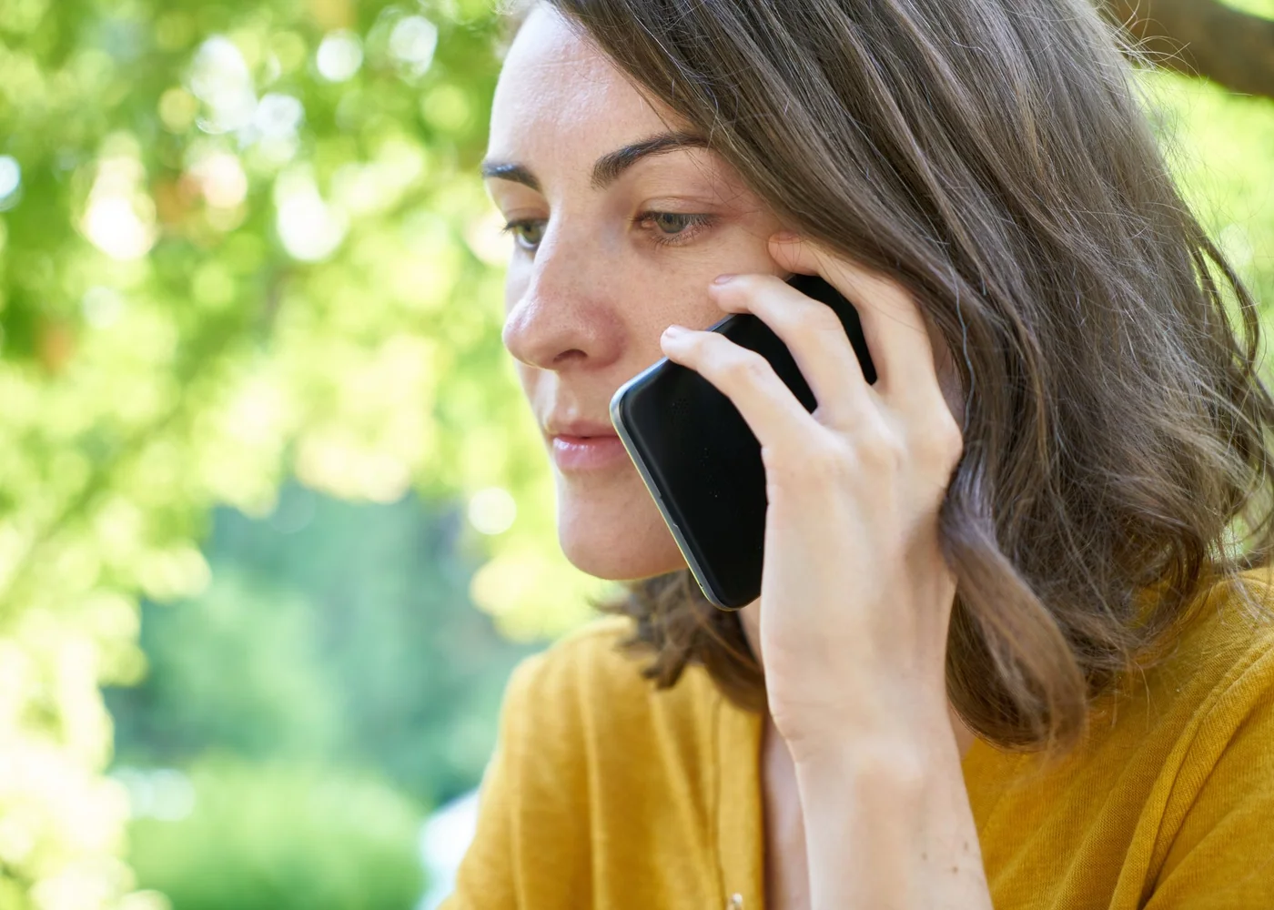Woman writing a simple weekly wellness plan in a sunny room